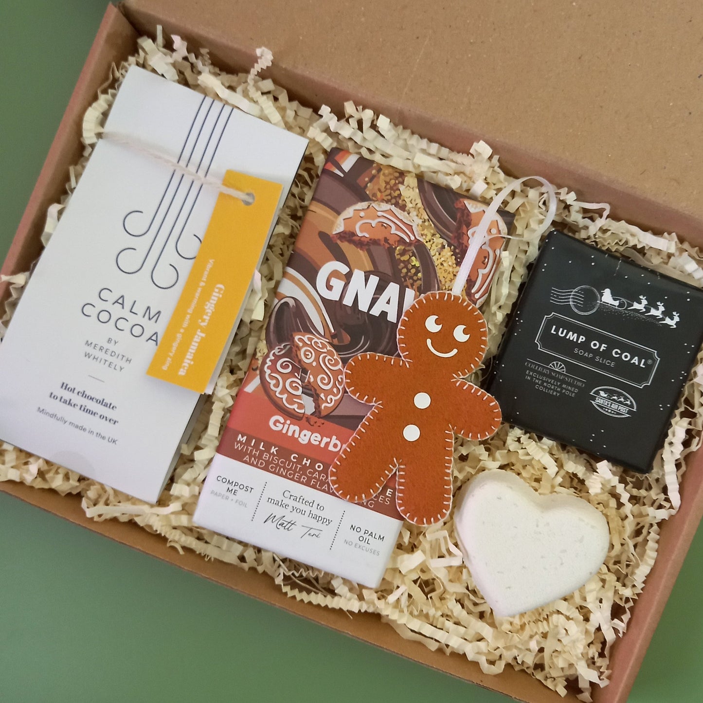 A gingerbread themed Christmas gift box containing ginger hot chocolate, soap, bath bomb and chocolate bar