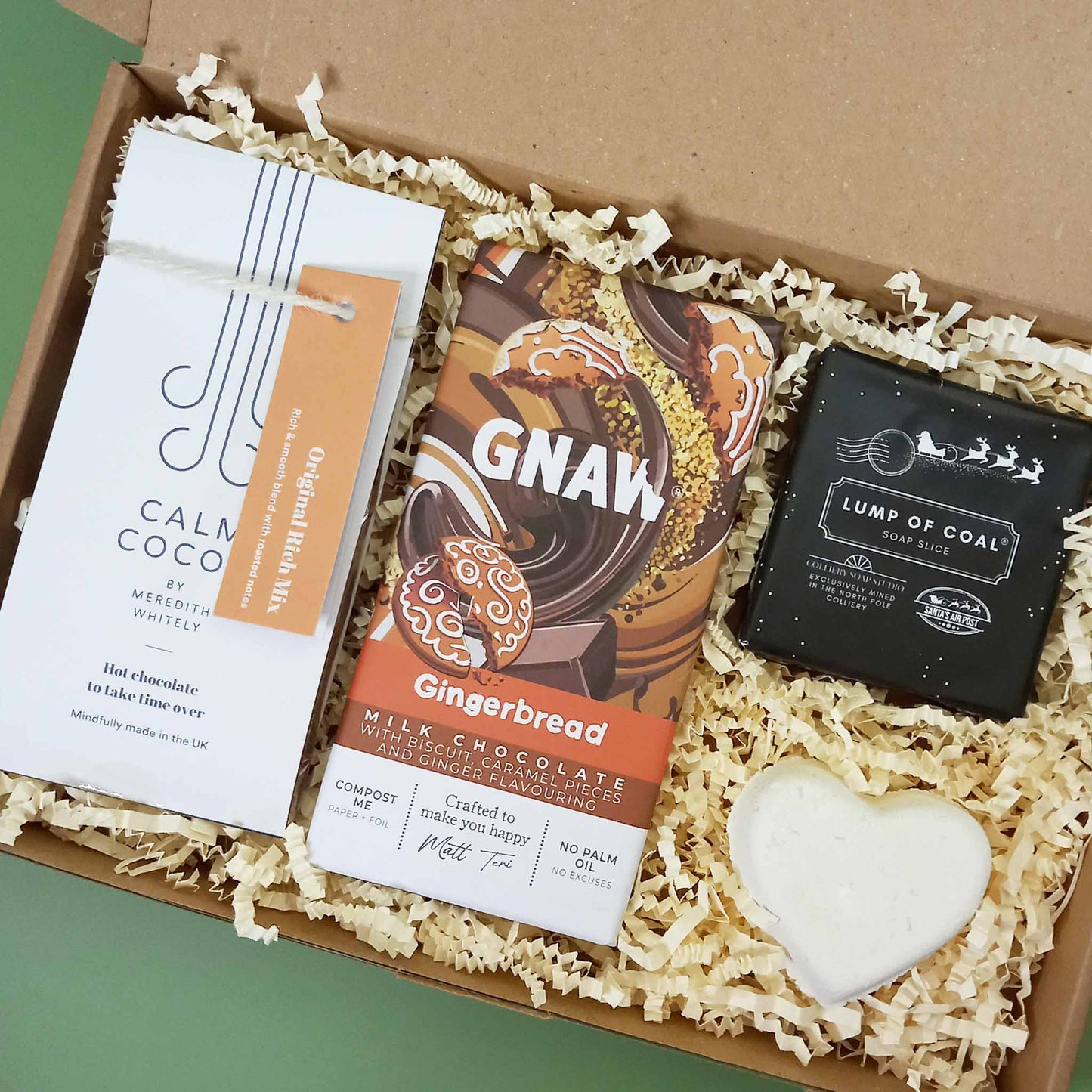 A gingerbread themed Christmas gift box containing hot chocolate, soap, bath bomb and chocolate bar