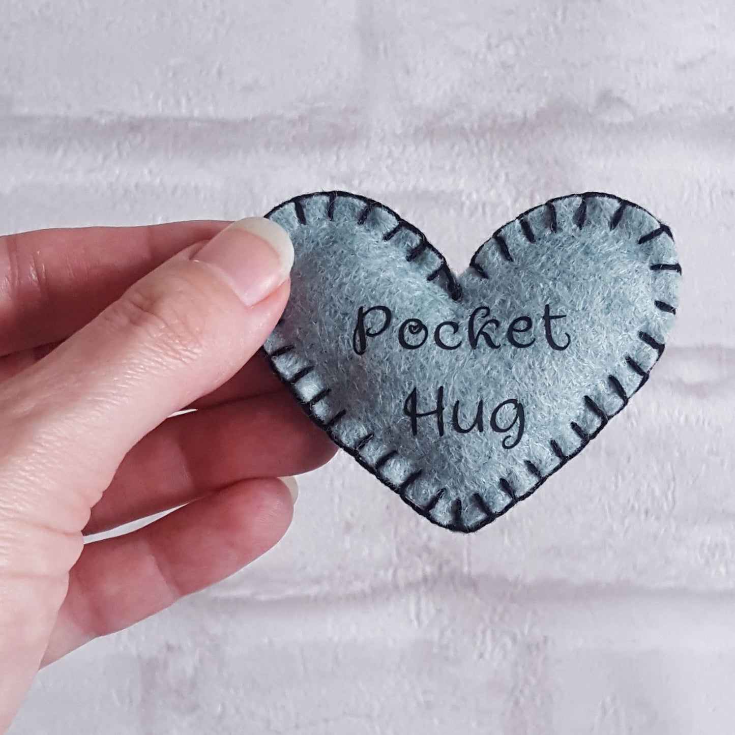 Turquoise felt heart shaped pocket hug
