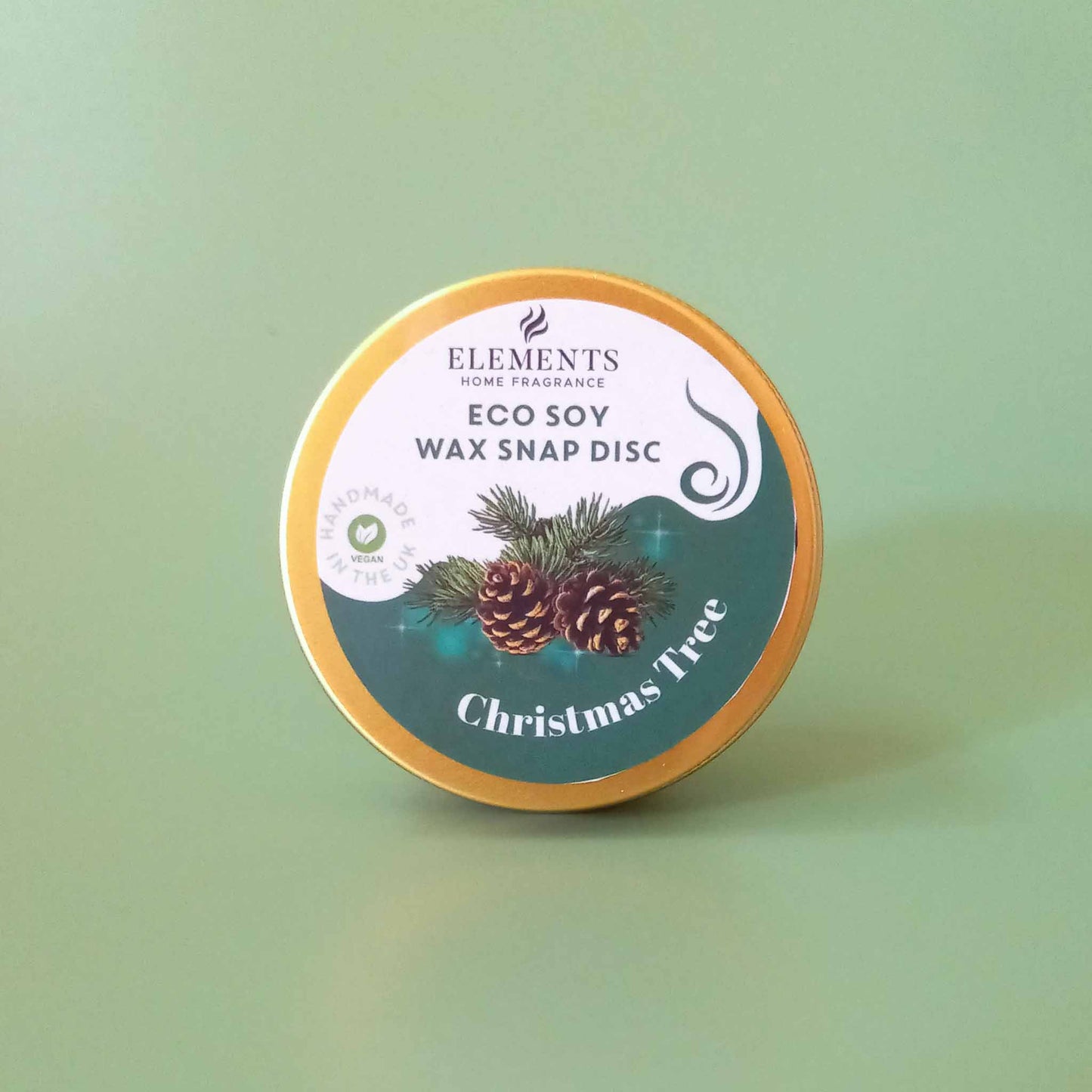 A round metal tin containing a Christmas tree scented wax melt snap disc