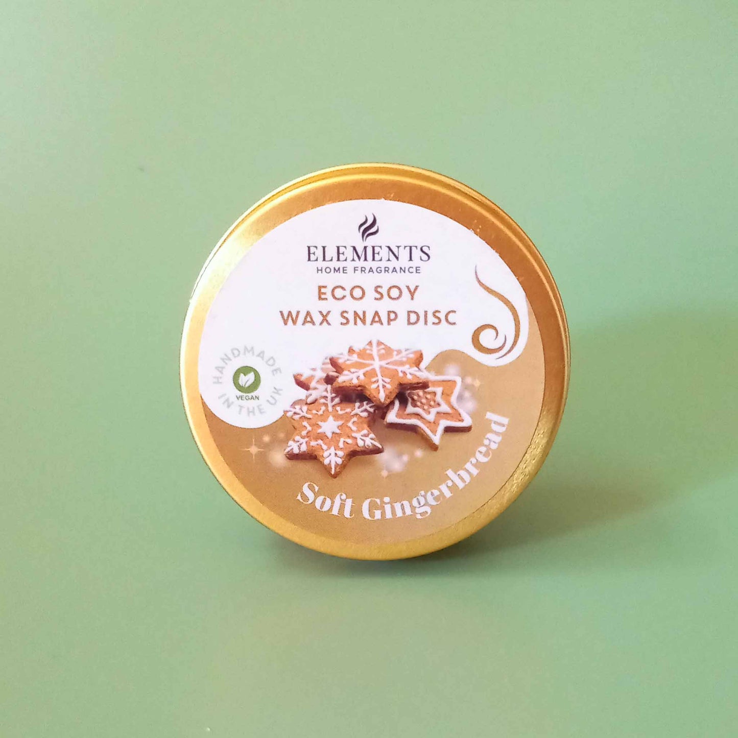 A round metal tin containing a gingerbread scented wax melt snap disc