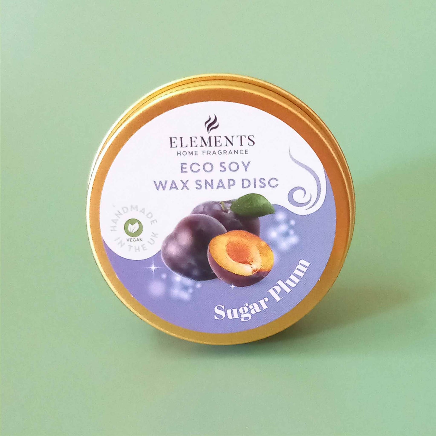 A round metal tin containing a sugar plum scented wax melt snap disc