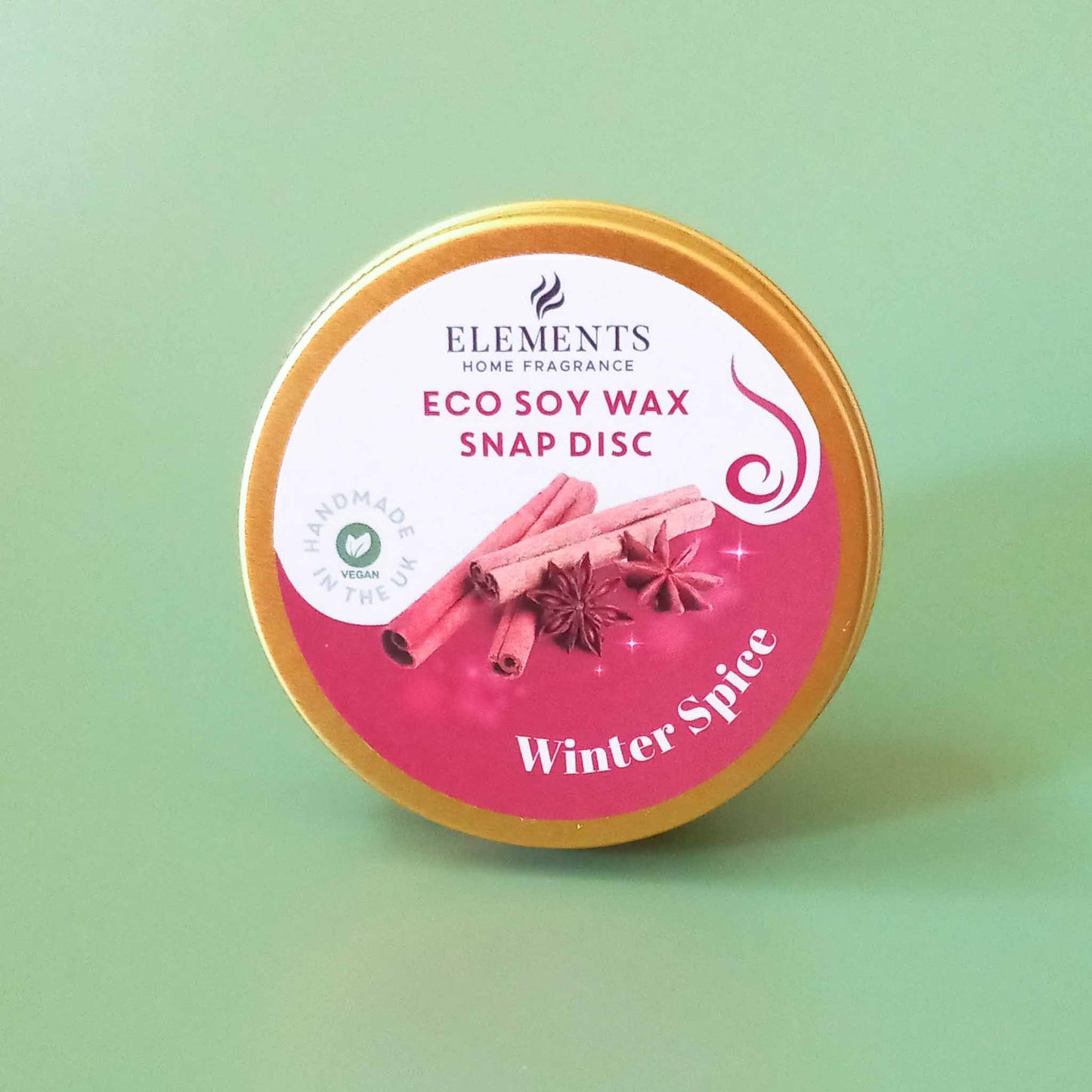 A round metal tin containing a winter spice scented wax melt snap disc
