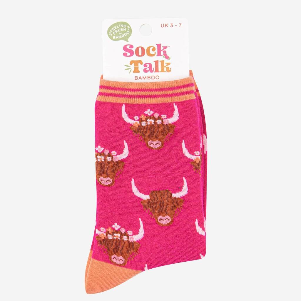 Cerise pink highland cow themed socks in recycled packaging