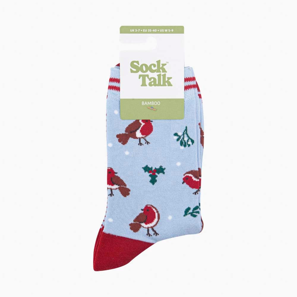 A packaged pair of light blue Christmas socks depicting robins, holly and mistletoe