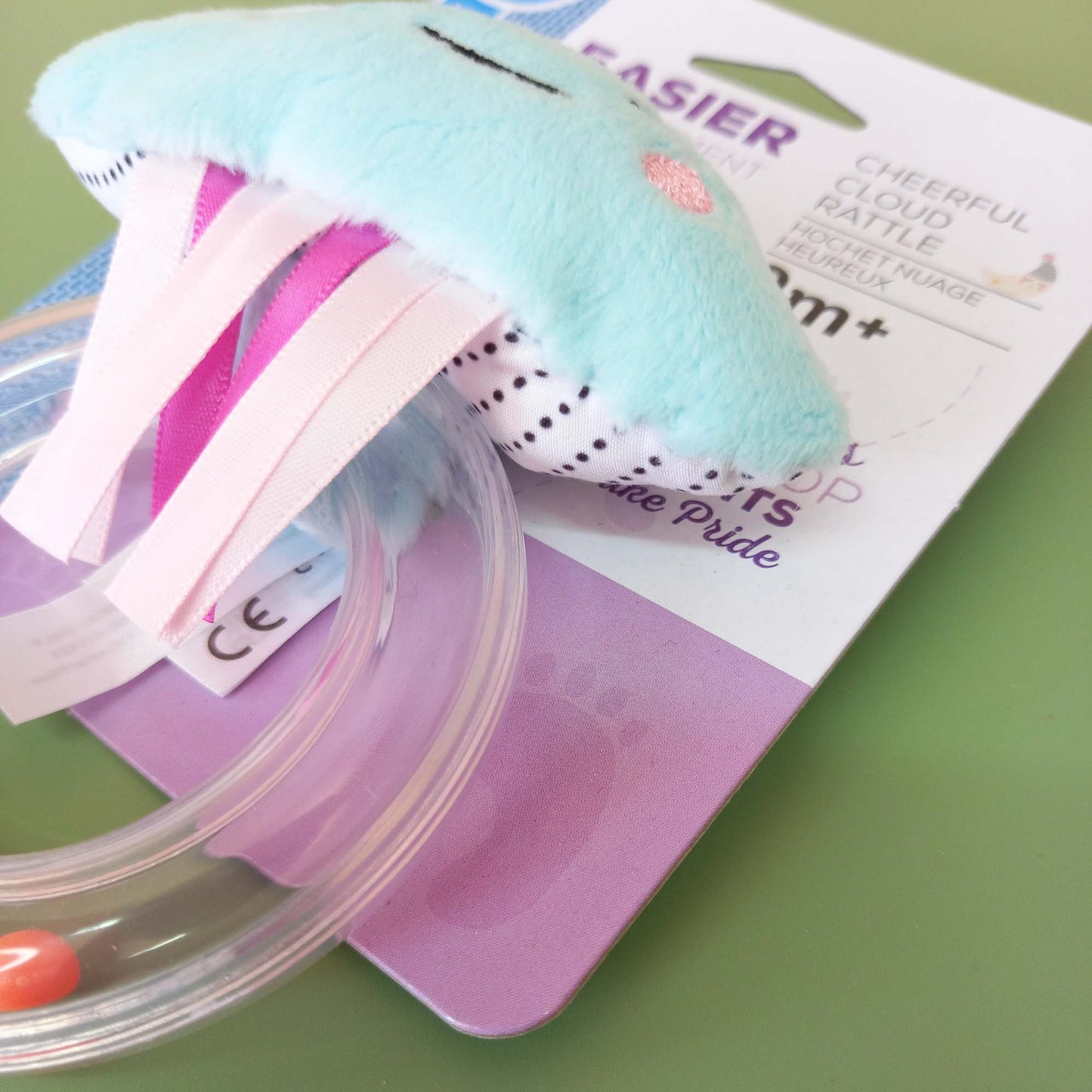 Closeup of cloud rattle showing spotty fabric backing