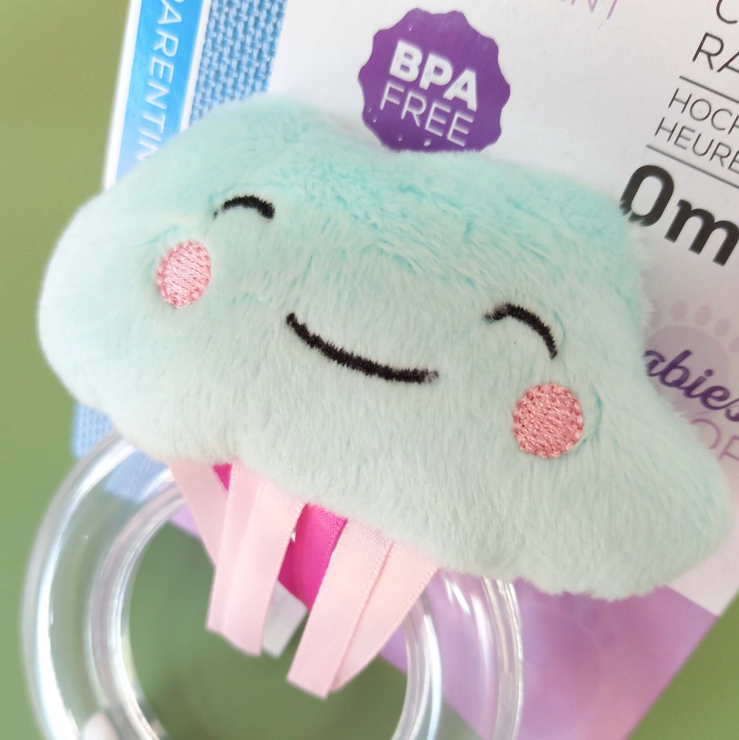 Closeup of faux fur cloud on rattle with smiling face