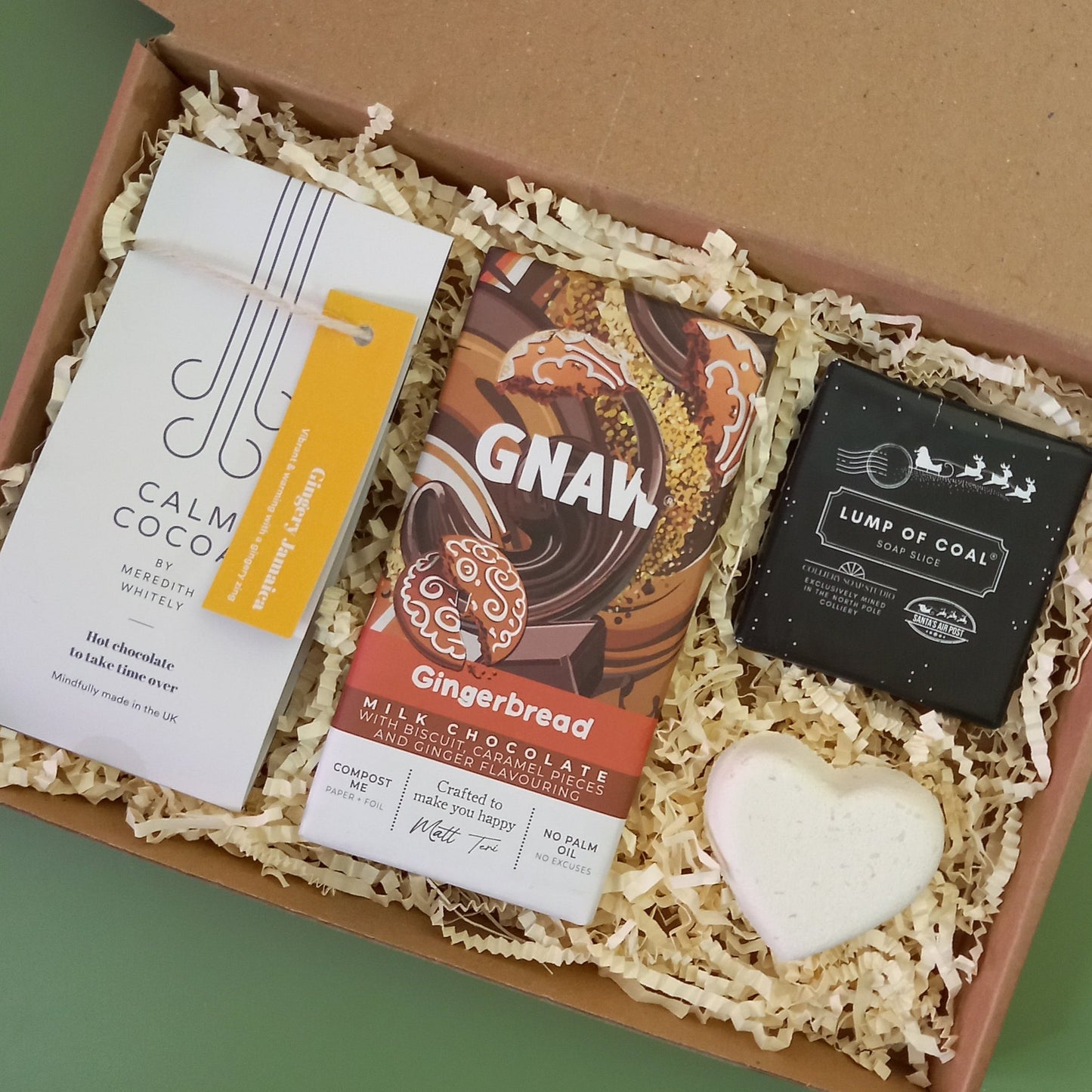A gingerbread themed Christmas gift box containing ginger hot chocolate, soap, bath bomb and chocolate bar