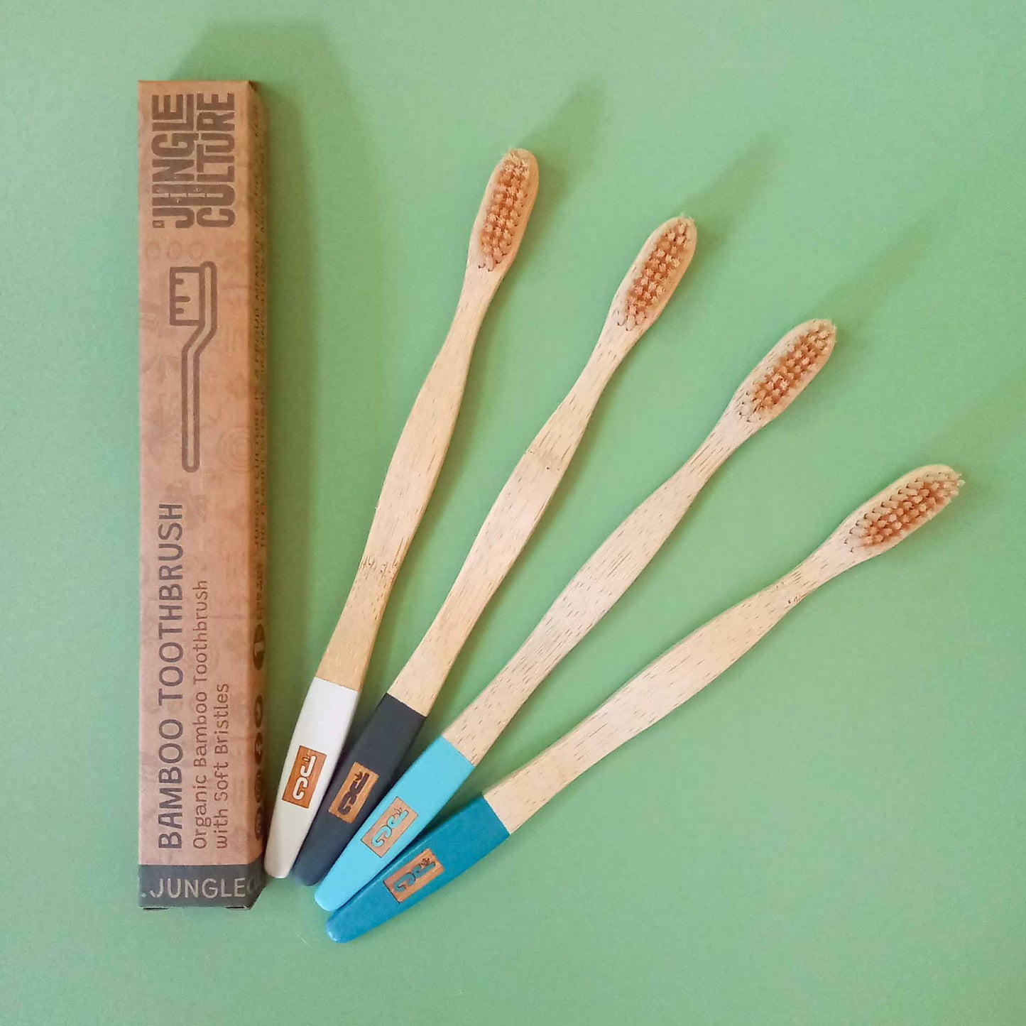 4 bamboo toothbrushes with various colour painted end of handles 