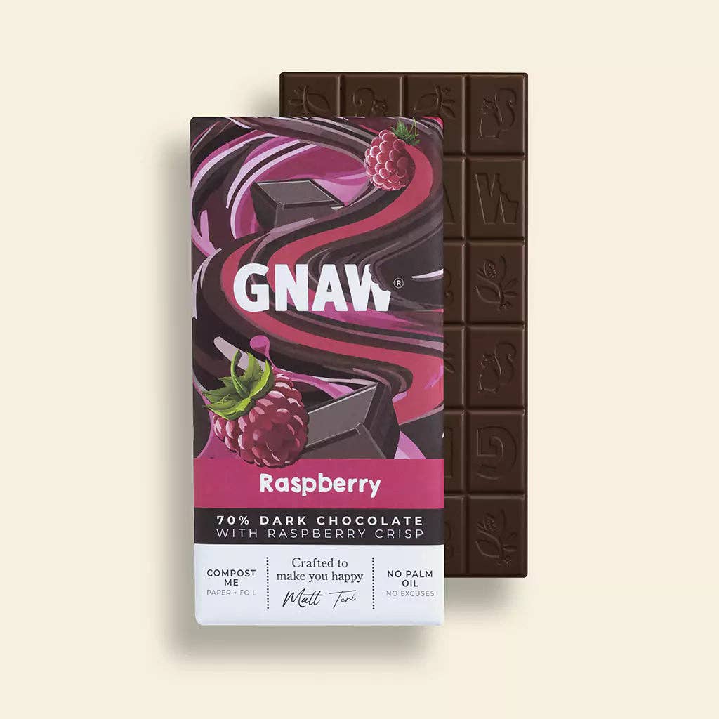 Dark chocolate bar with raspberry crisp and its packaging on a light beige background