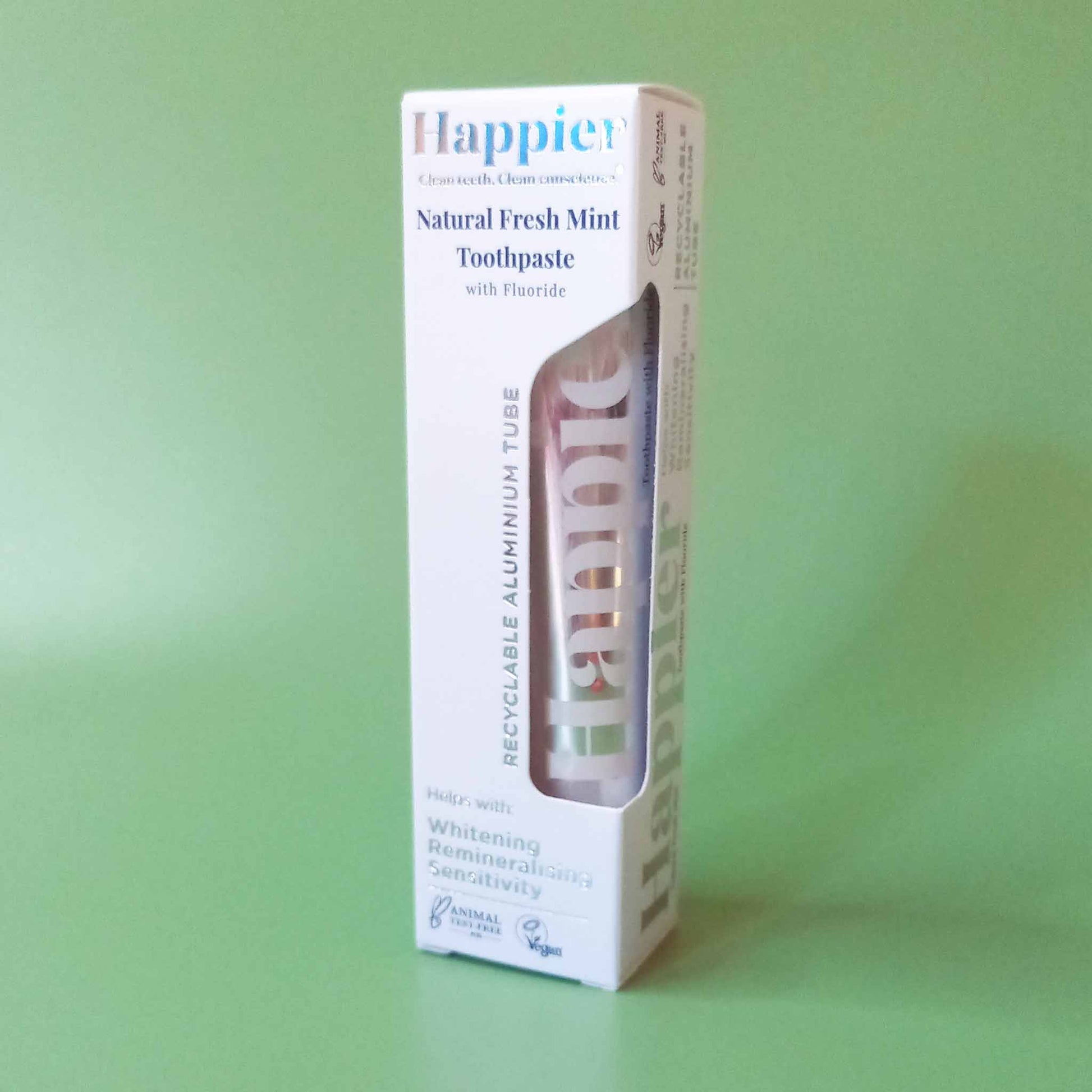 A boxed tube of Happier whitening toothpaste