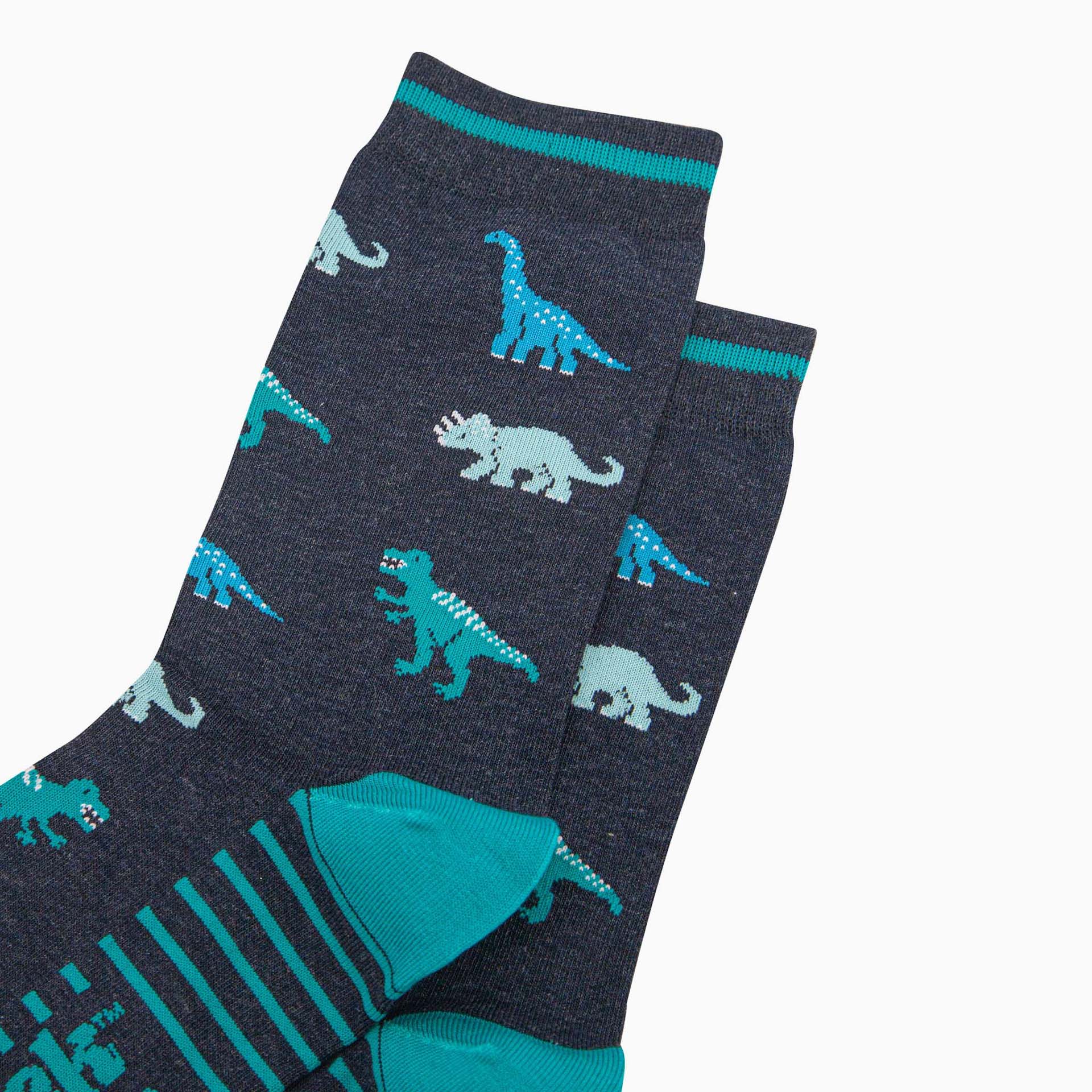 Navy socks with teal dinosaur patterns on a white background
