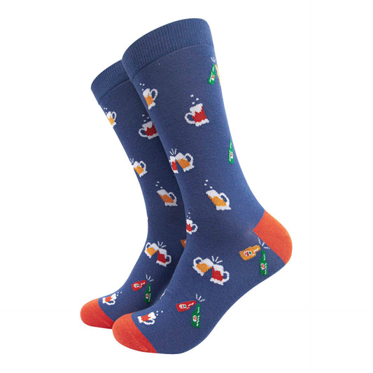 A pair of blue crew socks with orange heels and toes, featuring a repeating pattern of beer mugs and bottles