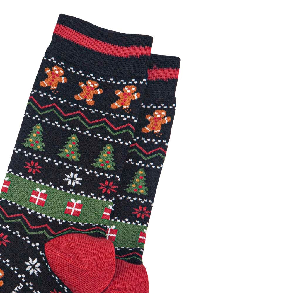 Close-up of a pair of black socks with  red, white and green Christmas Fair Isle style design