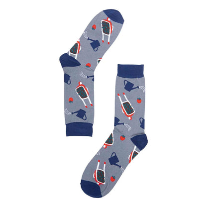 A pair of grey men's socks featuring wheelbarrows, water cans and tomatoes. With navy blue toes, heels and cuffs
