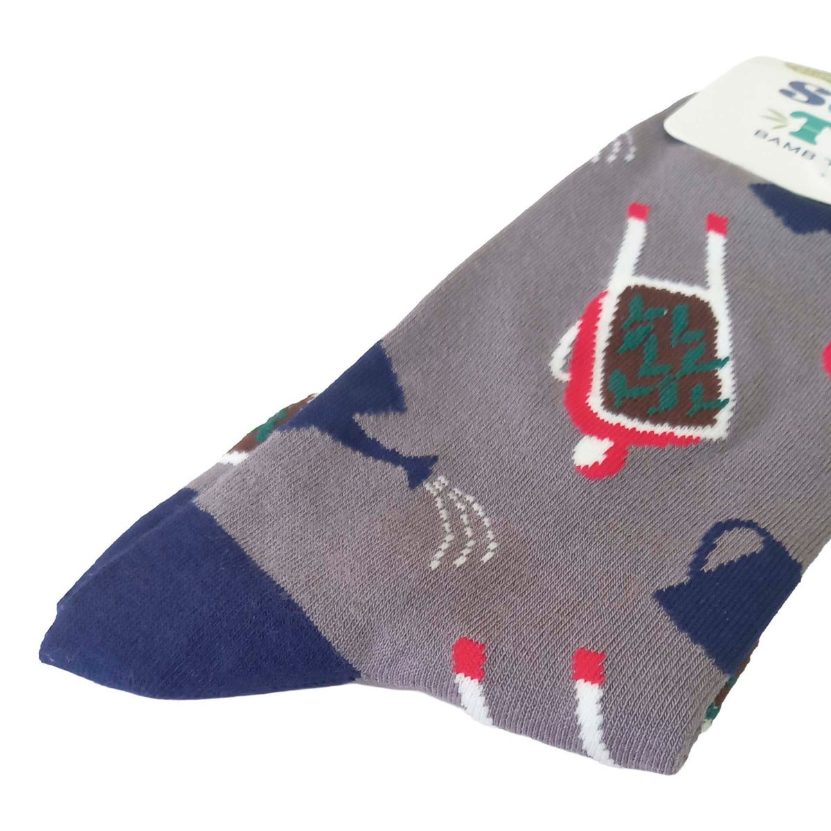 Closeup of a packaged pair of grey men's socks featuring wheelbarrows, water cans and tomatoes