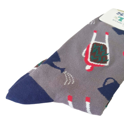 Closeup of a packaged pair of grey men's socks featuring wheelbarrows, water cans and tomatoes