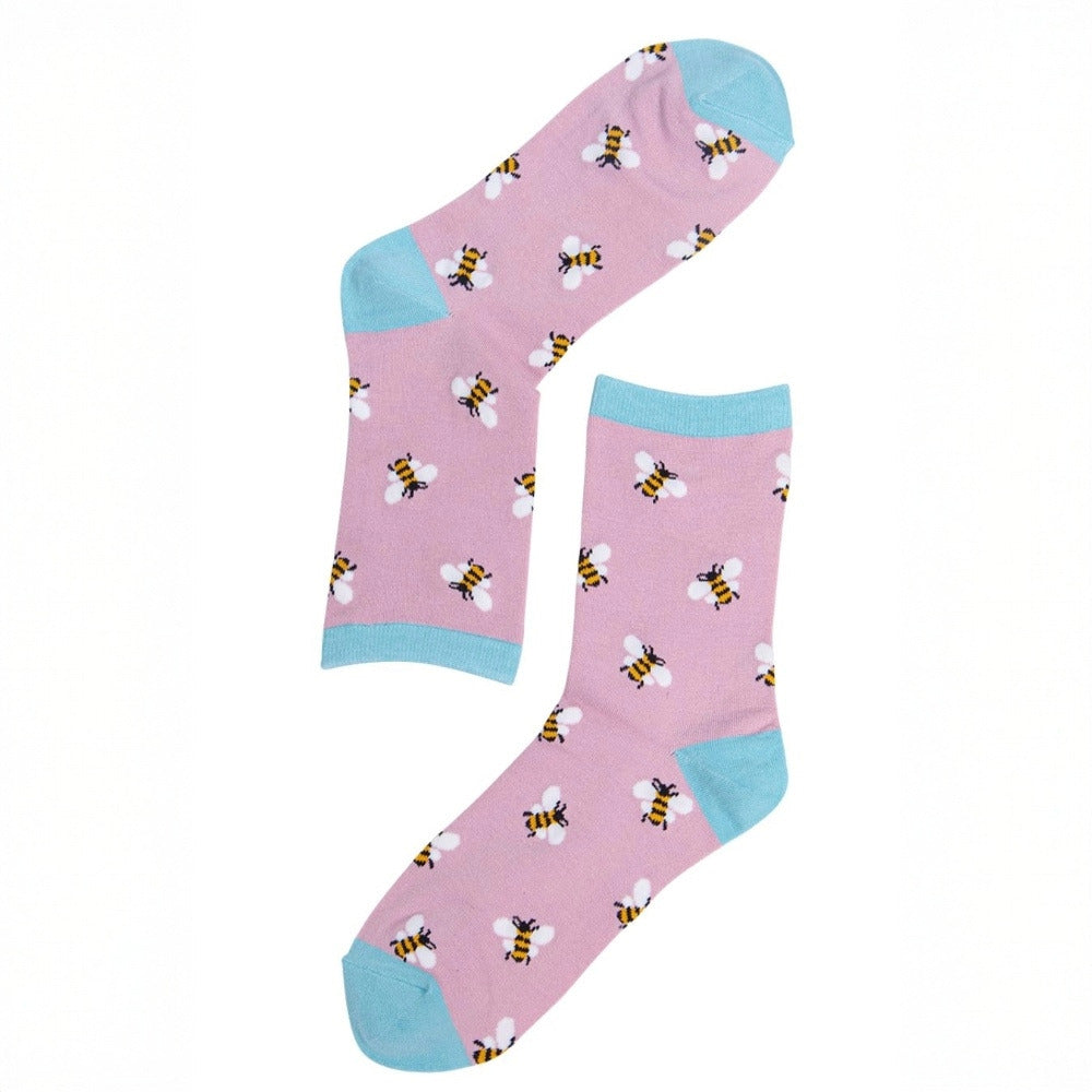 Pink socks with bee pattern and blue toes and cuffs on a white background