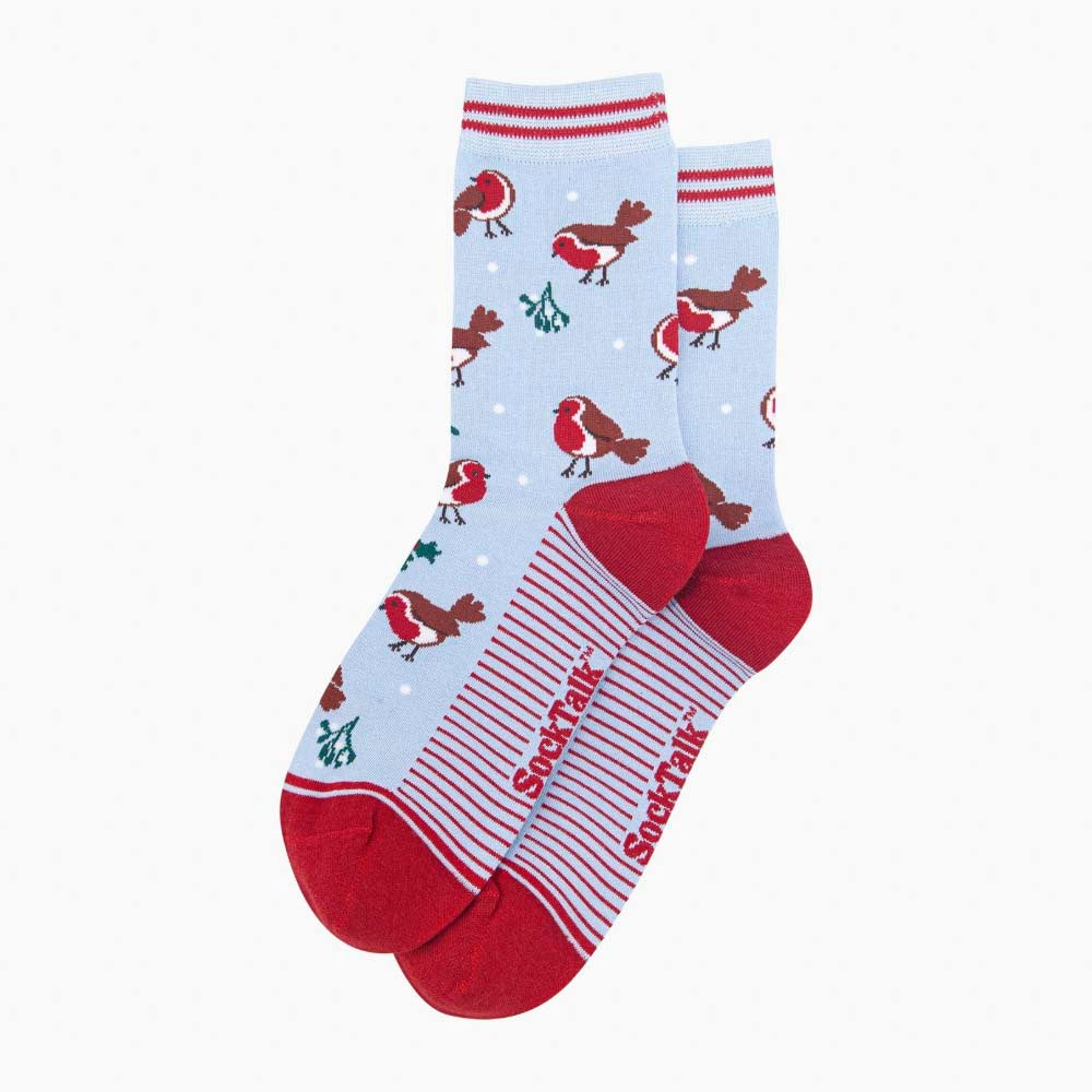 A pair of light blue socks with a repeating pattern of robins, holly and mistletoe. With red heels and toes and red striped cuffs