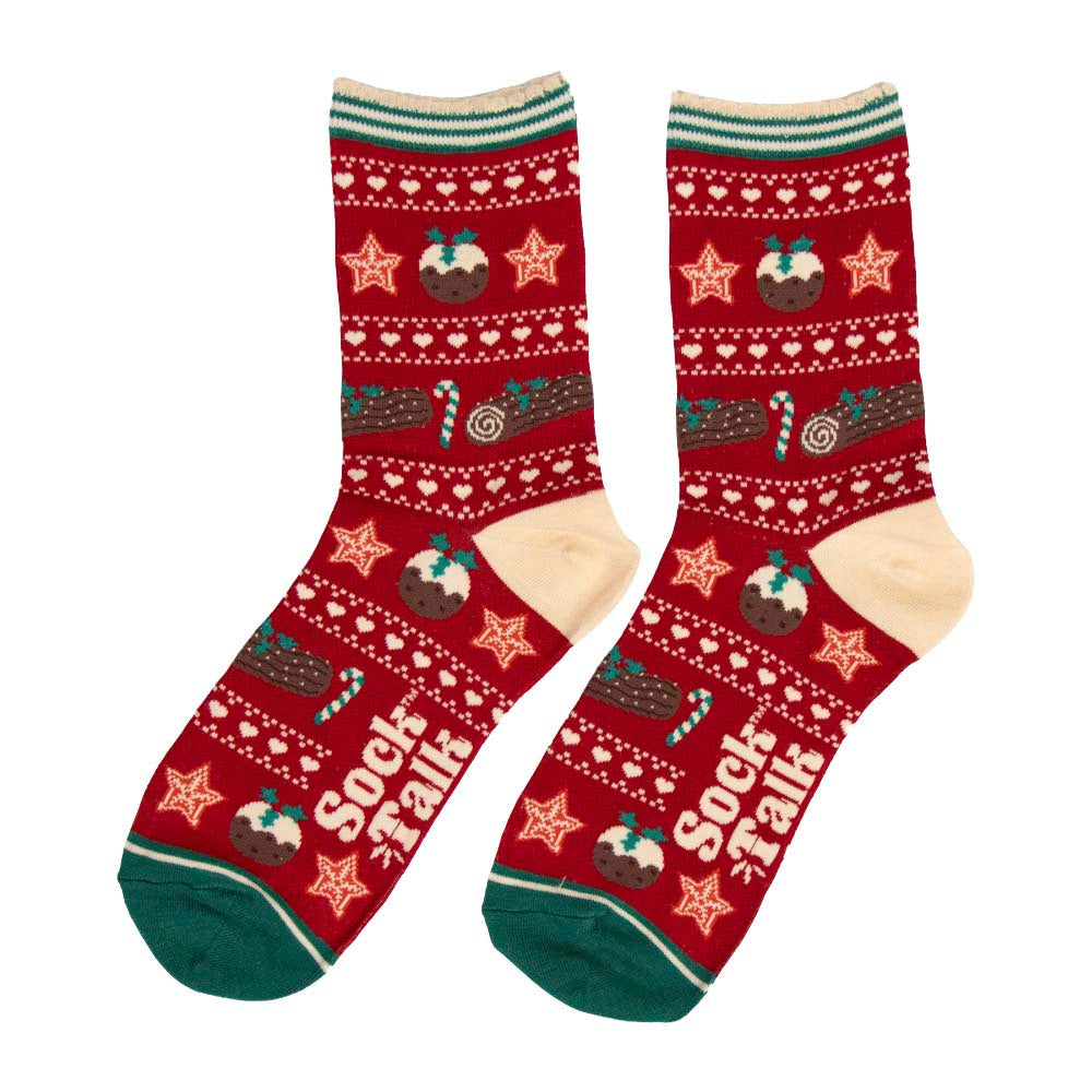 A pair of red and cream Christmas socks with green accents and featuring Christmas dessert designs 
