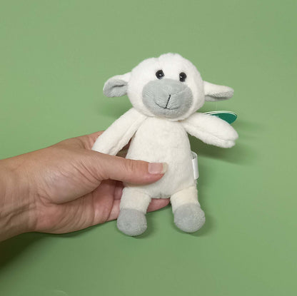 Hand holding mini lamb soft toy